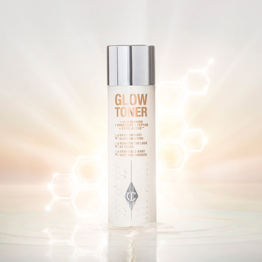 Glow Toner closed A large, clear bottle filled with luminous, cream-coloured watery toner with a silver-coloured lid.