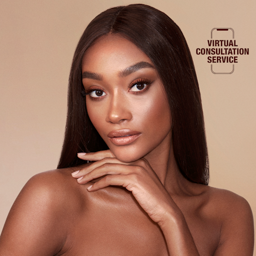 Charlotte Tilbury Airbrush Bronzer in Deep on deep-tone model Deep-tone brunette model wearing subtle glowy makeup with bronzed skin.