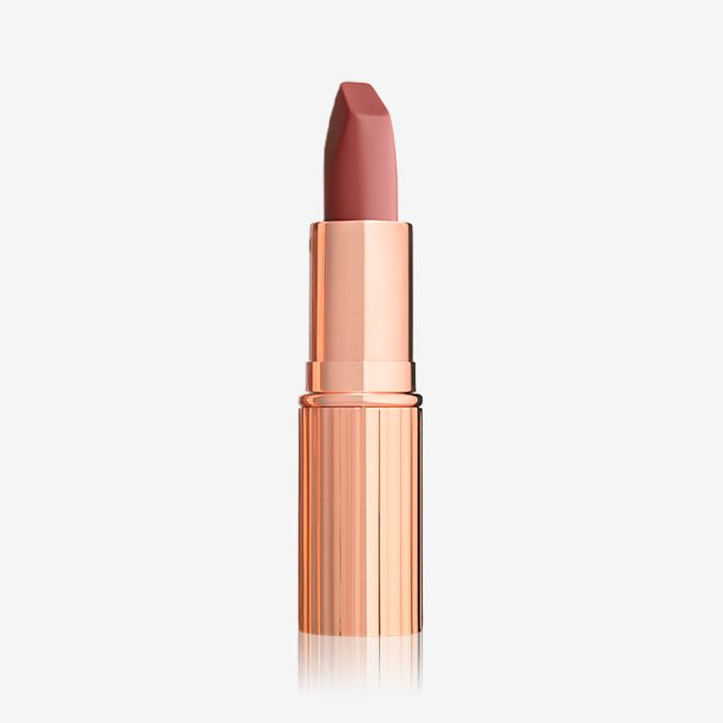 Matte Revolution in Rose Kiss open An open matte lipstick in a warm coral rose with a gold-coloured tube.