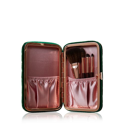 Charlotte's Hollywood Mini Brush Set open An open purple and pink-coloured brush set with face and eye brushes.