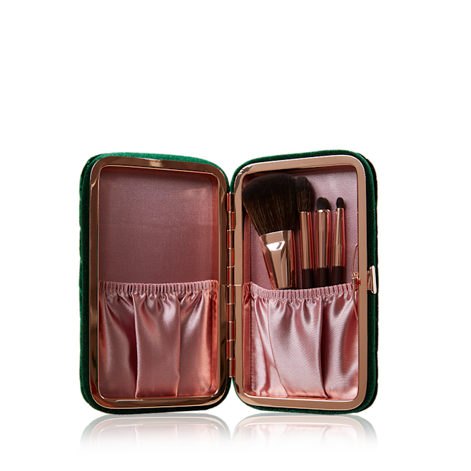 Charlotte's Hollywood Mini Brush Set open An open purple and pink-coloured brush set with face and eye brushes.