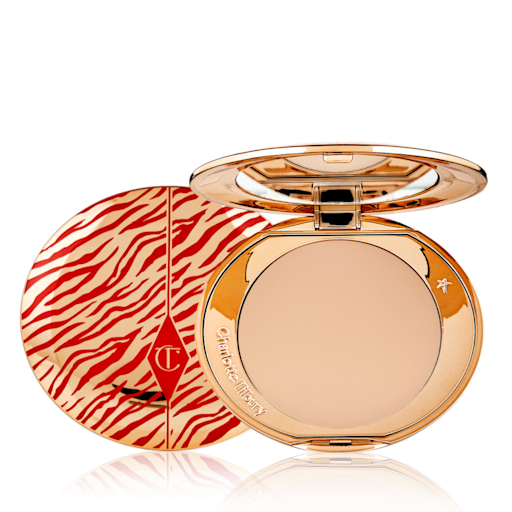 Airbrush Flawless Finish Powder in Medium Lunar New year open An open, pressed powder compact for medium skin tones with a mirrored lid, in gold-coloured packaging with red-coloured tiger stripes on the lid.