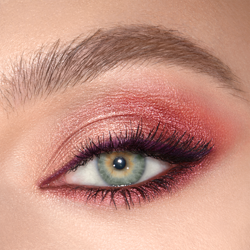 Luxury Palette Mesmerising Maroon Eyeshadow look close-up Close-up of a shimmery, peach, plum, and champagne eye look on a fair-tone model with green eyes.