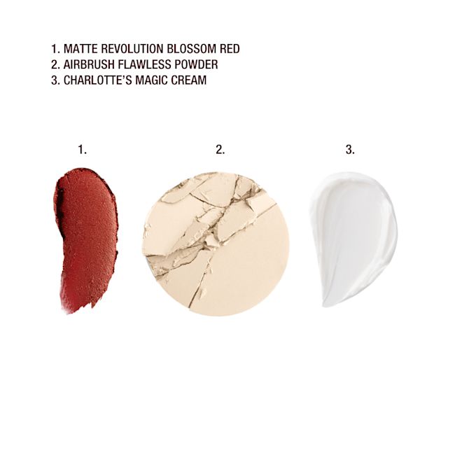 Lucky New Year Beauty Secrets swatches Swatch of a matte burnt-orange red lipstick, pearly white face cream, and setting powder in a light beige shade.