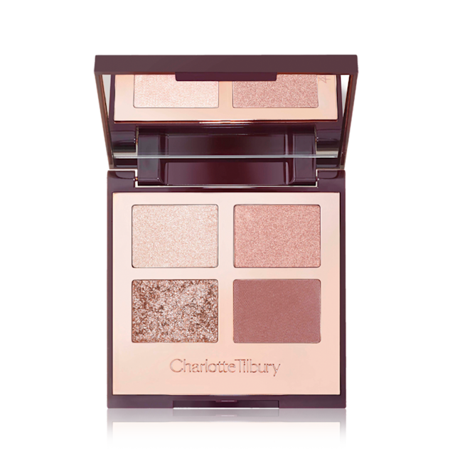 Bigger Brighter Eyes Palette open An open, mirrored-lid eyeshadow palette in nude pink, gold, and brown shades.