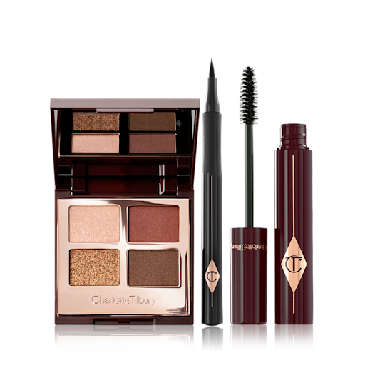 Bella Sofia Eye Kit open An open, mirrored-lid eyeshadow palette in matte and shimmery brown and gold shades, an open black eyeliner pen, and an open mascara with its applicator in a dark-crimson colour scheme.