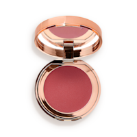 Pillow Talk Lip and Cheek Glow in Colour of dreams open An open, mirrored-lid lip and cheek cream compact in a warm rosebud-pink shade.