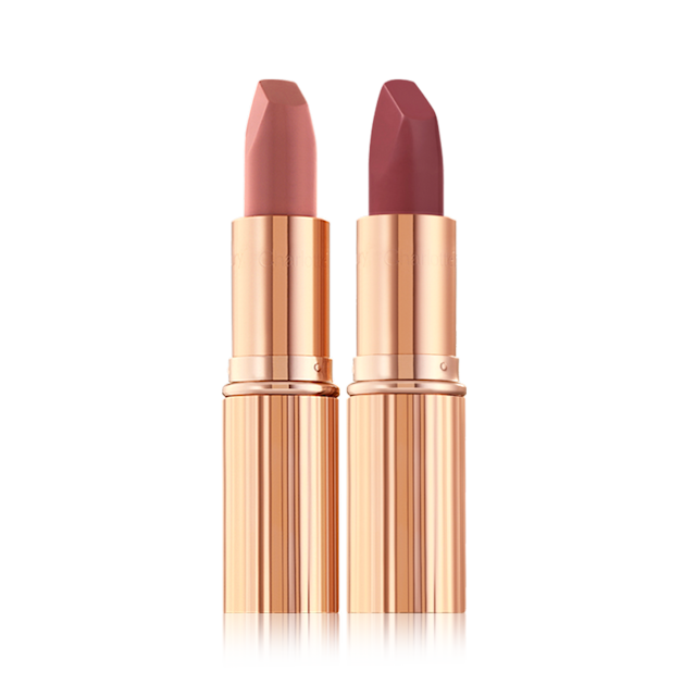 Matte Revolution Pillow Talk duo open Two matte lipsticks, one a nude pink and the other a berry-rose shade in golden, metallic tubes with their lids removed.