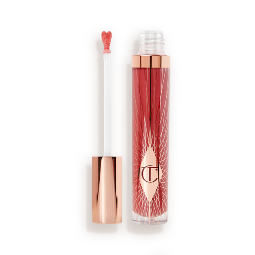 Collagen Lip Bath in Walk of No Shame open A lip gloss in a berry-pink shade with its heart-shaped applicator next to it.