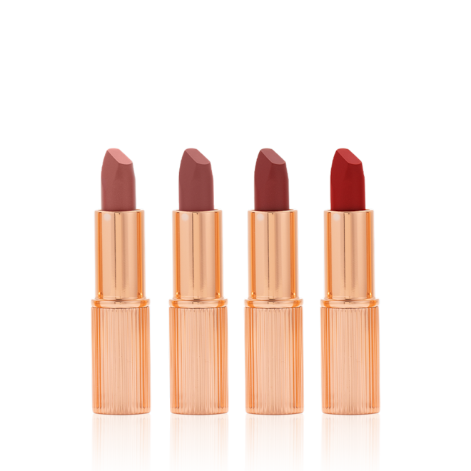 Charlotte Tilbury's Magic Icons kit open Five matte lipsticks in nude shades of red and pink in sleek, gold-coloured tubes with their lids removed.