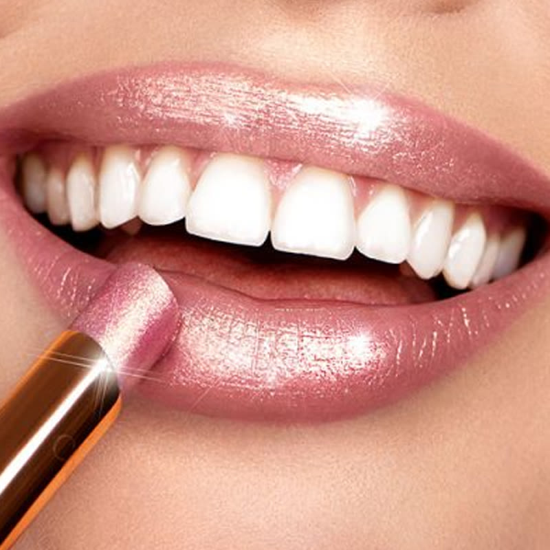 pillow talk diamonds on lips close-up Lips close-up of a light-tone model applying a shimmery, sheer, nude-pink lipstick.