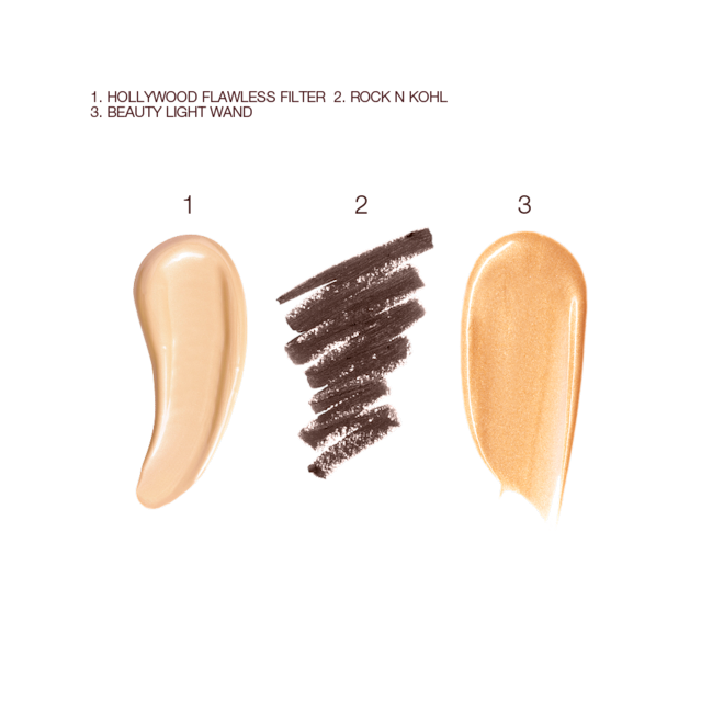 Smokey Eye Glowing Skin Makeup Kit swatches Swatches of a luminous, champagne-coloured creamy primer, a kohl liner in dark brown, and a highlighter in a warm golden shade.