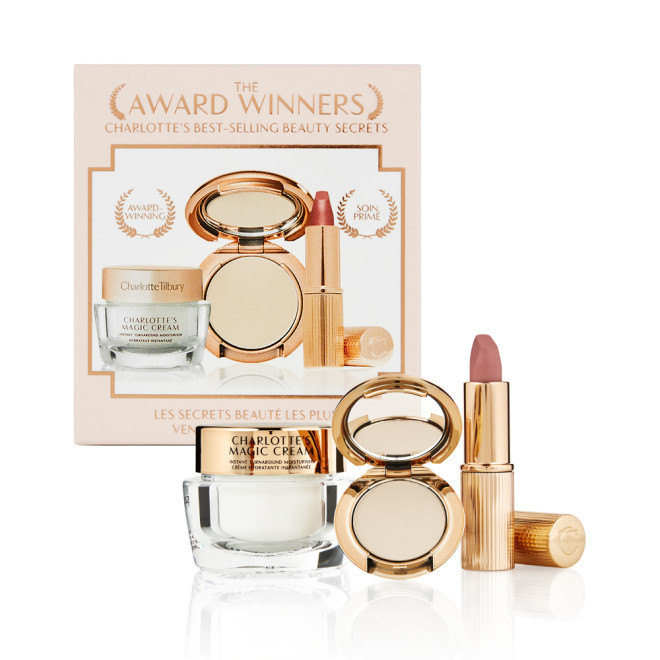 Pearly-white face cream in a glass jar with a gold-coloured lid, pressed powder compact in a fair shade, and a dusky pink lipstick in a sleek gold-coloured tube.