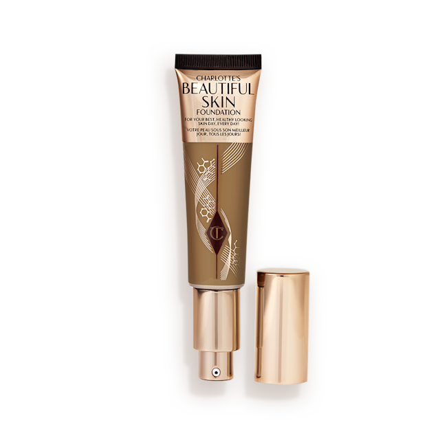 Beautiful Skin Foundation in 12N open An open foundation wand in gold packaging with a pump dispenser and a dark-brown-coloured body to show the shade of the foundation inside.