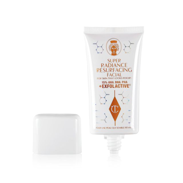 Super Radiance Resurfacing Facial open An open, exfoliating, wash-off, chemical mask in a white-coloured tube with gold-coloured text on it with its white-coloured lid next to it.