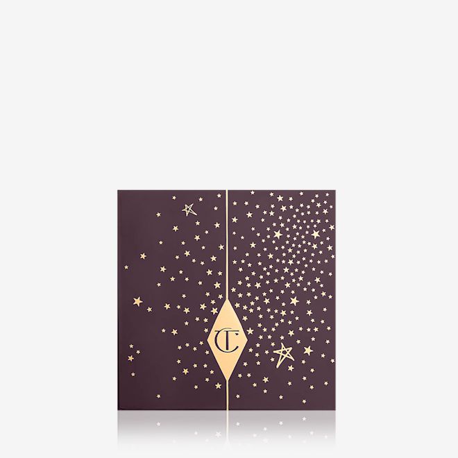 Luxury Palette in Legendary Muse closed A closed eyeshadow palette with a dark brown lid with gold speckles all over and the CT logo printed on it.