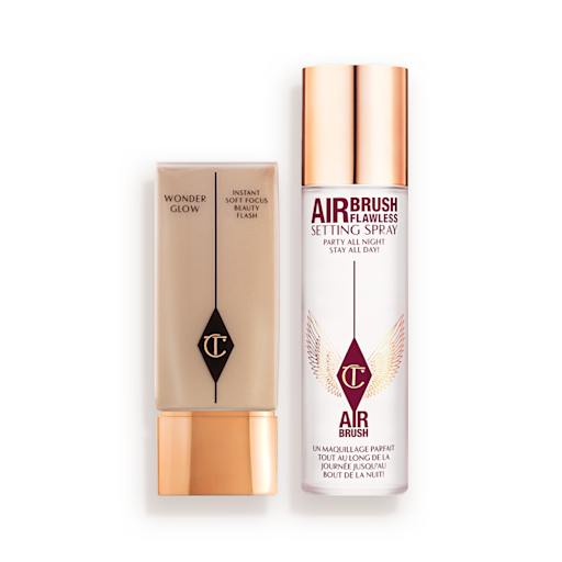 Prime, Set, and Glow Kit closed Foundation in a rectangular, clear bottle with a gold-coloured lid and setting spray in a large, clear bottle with a gold-coloured lid.