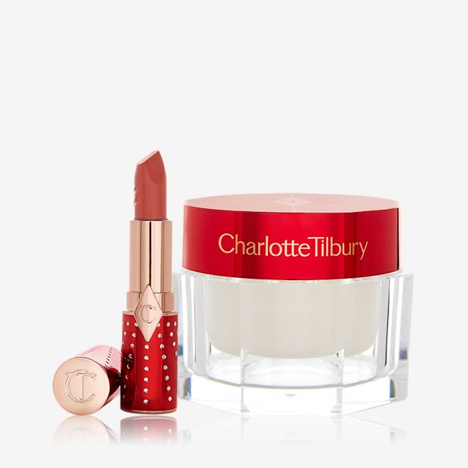 Magic Cream with Lipstick An open lipstick in red and gold packaging in a dark brown-peach shade with a face cream in a pearly-white colour in a glass jar with a red-coloured lid.