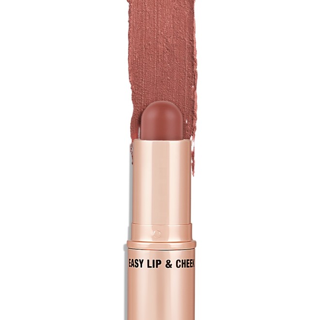 An open, lip and cheek colour stick in a glowy brown-pink shade in a golden-coloured tube.