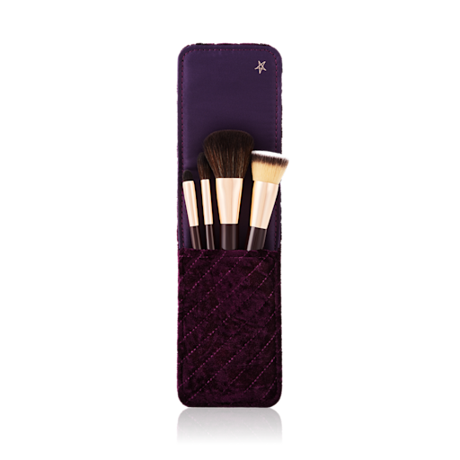 Charlotte's Magic Mini Brush Set open An open makeup clutch brush gift set in brown colour, which includes a foundation brush, powder brush, an eyeshadow brush, and bronzing brush.