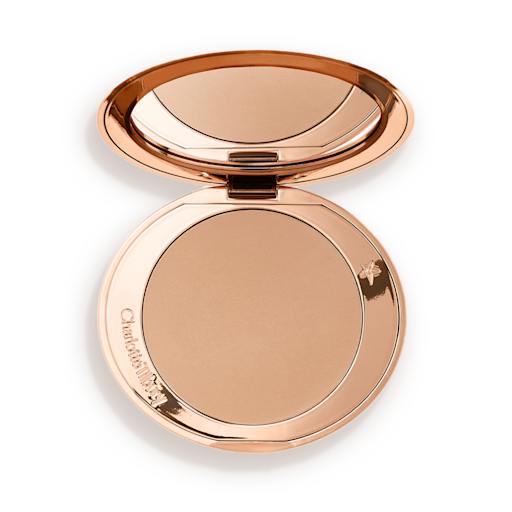 Airbrush Bronzer in Fair open An open mirrored-lid bronzer compact in a light shade.