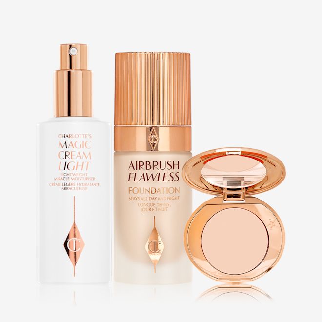 Airbrush Hydrate, Perfect + Correct Kit displayed Face cream in a white-coloured bottle with a gold-coloured pump dispenser, foundation in a frosted glass bottle with a gold-coloured lid, and pressed powder compact with a mirrored-lid.