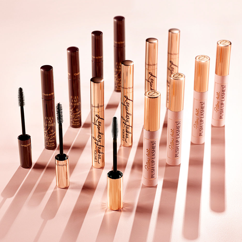 Full Fat Lashes, Legendary Lashes Volume 2 and Pillow Talk Push Up Lashes! mascara collection A collection of three different mascaras, one in dark crimson tube, the second in golden, and the third in a nude pink bottle with a gold-coloured lid. All three with their applicators in front of them.