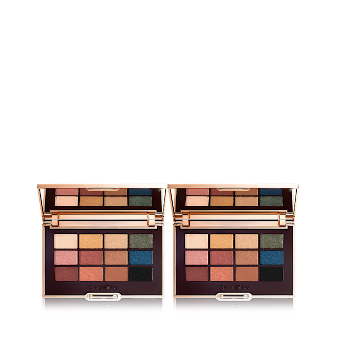 The Icon Palette Duo open Two open, mirrored-lid eyeshadow palettes with nude brown, green, blue, black, gold, and pink shades.
