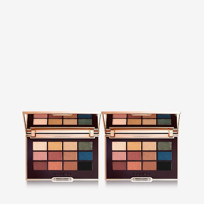 The Icon Palette Duo open Two open, mirrored-lid eyeshadow palettes with nude brown, green, blue, black, gold, and pink shades.