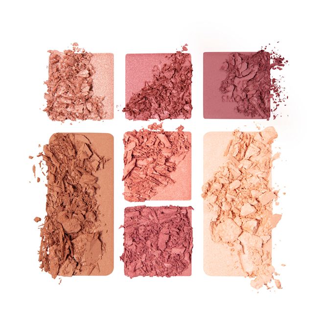 Instant Look in a Palette in Sunset Dreamscape swatches Swatches of a face palette with three rose gold, dusky pink, and plum-coloured eyeshadows, two blushes in soft peach and medium-pink, light brown bronzer, and soft, gold-coloured highlighter.