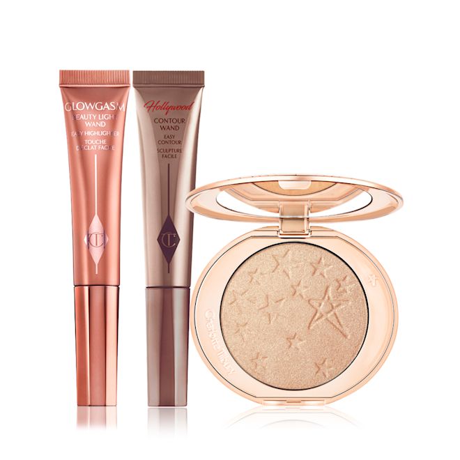 Beauty Light Wand in Spotlight and Pinkgasm and Hollywood Glow Highlighter Highlighter wand in candlelight gold packaging and highlighter blush wand in rose gold packaging and powder highlighter compact with a mirrored lid in a soft champagne shade