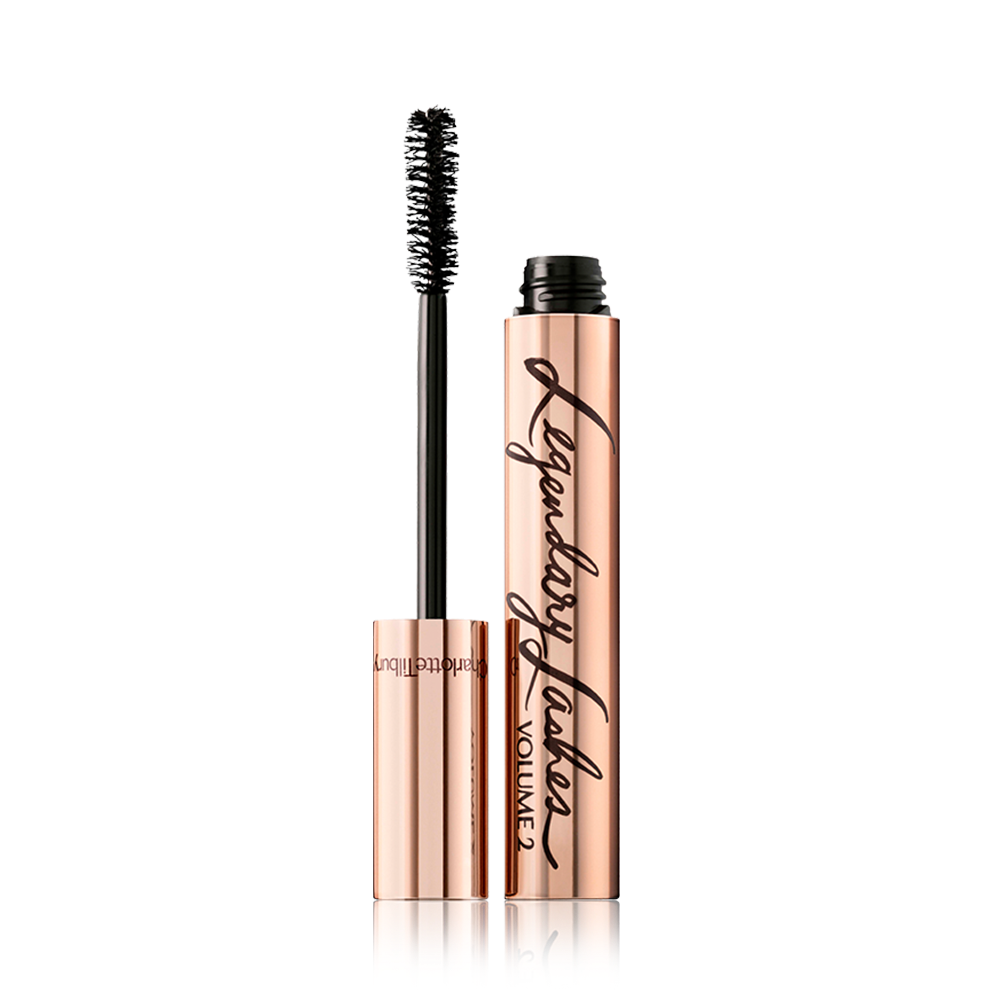 Legendary Lashes Volume 2 open An open, black mascara in reflective, golden-coloured packaging with its applicator next to it.