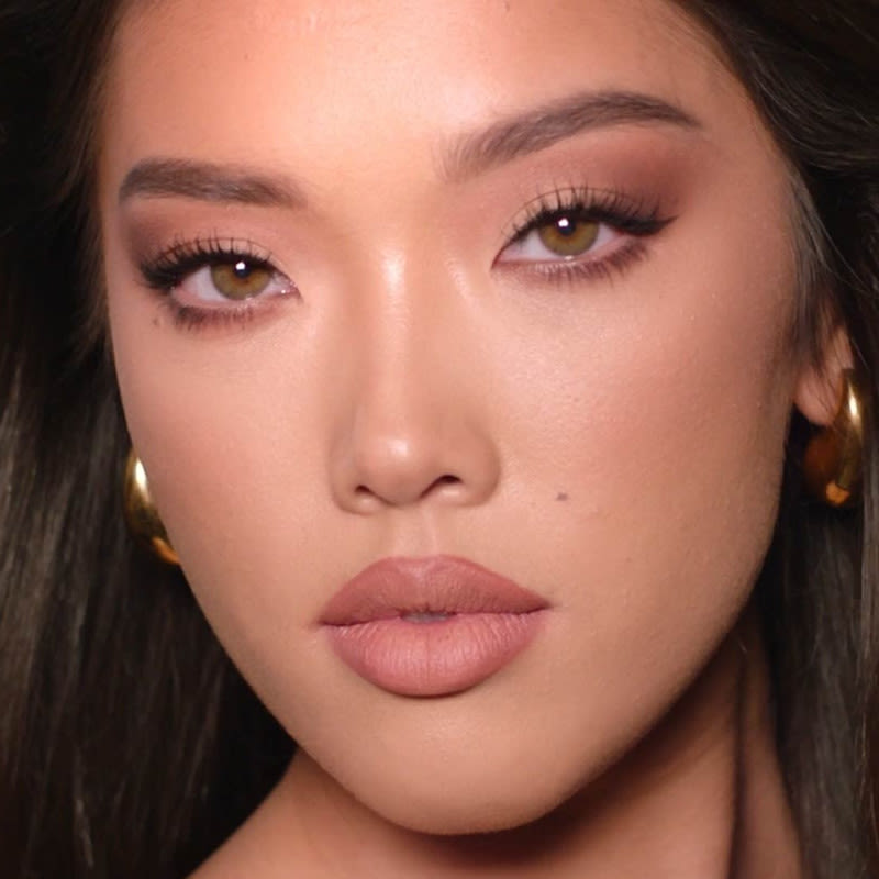 90s Makeup Look Model wearing Charlotte's 90s makeup look with 90s nude lips and supermodel-inspired eyes