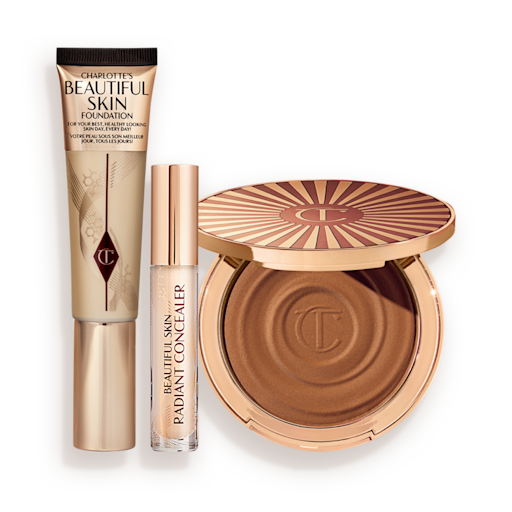Beautiful Skin 3-Step Routine Kit displayed Foundation in a sleek gold-coloured tube with a concealer in a glass tube and gold-coloured lid, and dark brown cream bronzer compact in gold-coloured packaging.