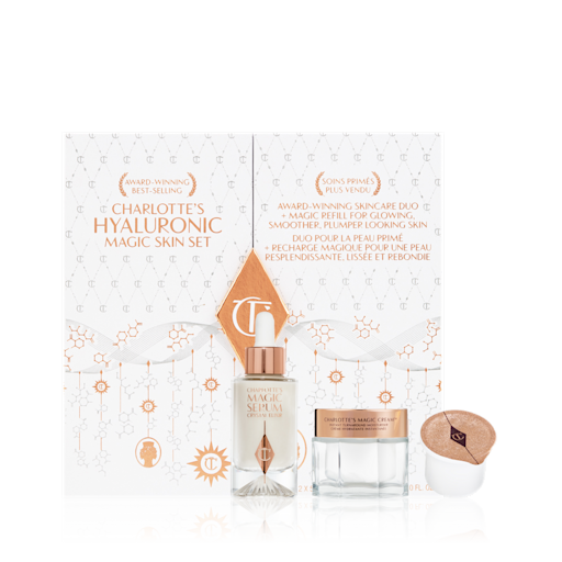 Hyaluronic Magic Skin Set displayed White and gold-coloured skincare box that includes a luminous face serum in a glass bottle and pearly white face cream in a glass jar with a gold-coloured lid that comes with a sample.