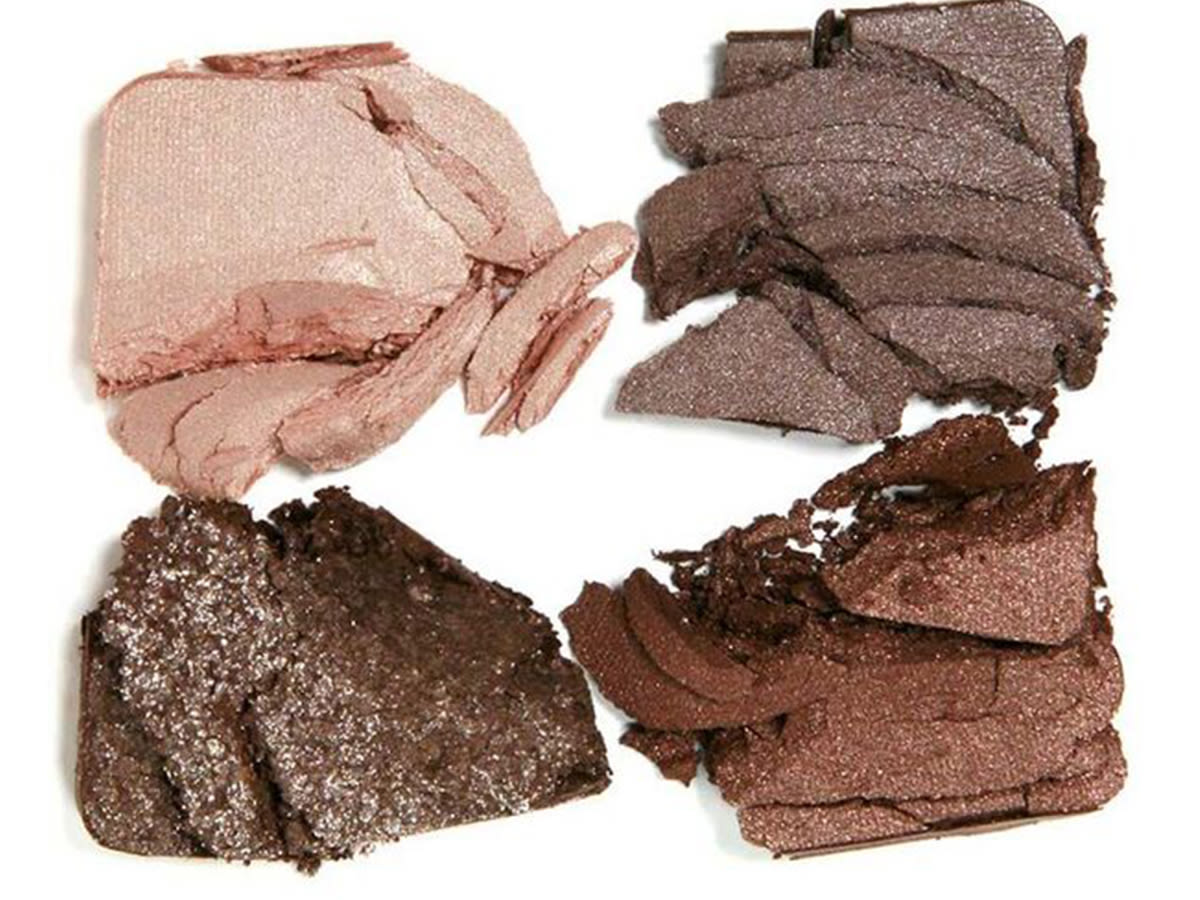 Glowing Goddess Palette swatches Swatches of a quad eyeshadow palette in matte and shimmery beige, graphite, grey-brown, and dark brown.