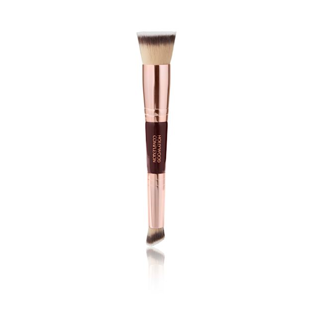 Hollywood Complexion Brush A double-ended face brush for contouring, applying foundation, blush, and bronzer, with the handle in black and gold colour and the synthetic bristles in grey-blonde and black colours.