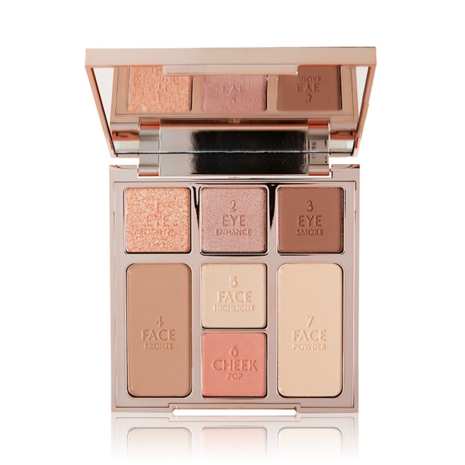 An open, mirrored-lid face palette with nude eyeshadows, nude pink and soft pink blushes, bronzer, and highlighter. 