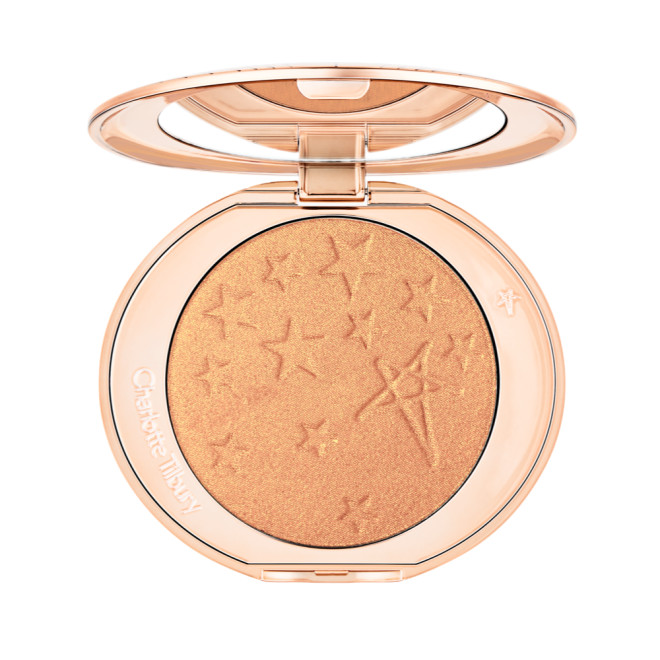 An open highlighter powder compact in a true gold shade with a mirrored lid.