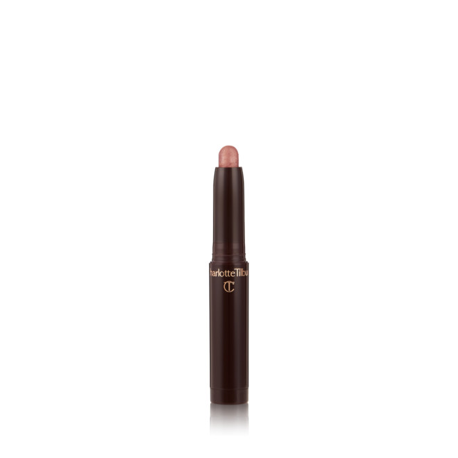 An open, cream eyeshadow wand in a sultry- sunset-pink shimmer shade.