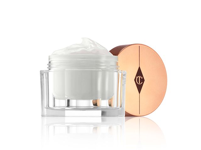 Magic Cream lid removed Thick, pearly-white cream in an open glass jar with its rose-gold-coloured lid next to it.