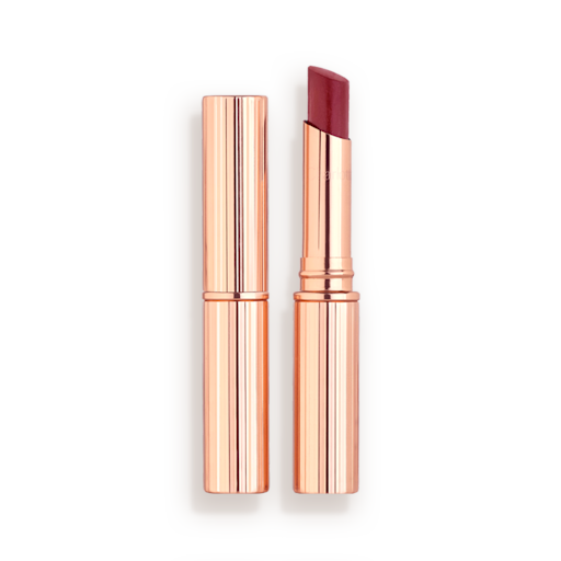 Superstar lips in Walk of No Shame with and without lid Two lipstick lip blams, with and without lid, in a berry-pink shade with gold-coloured packaging.