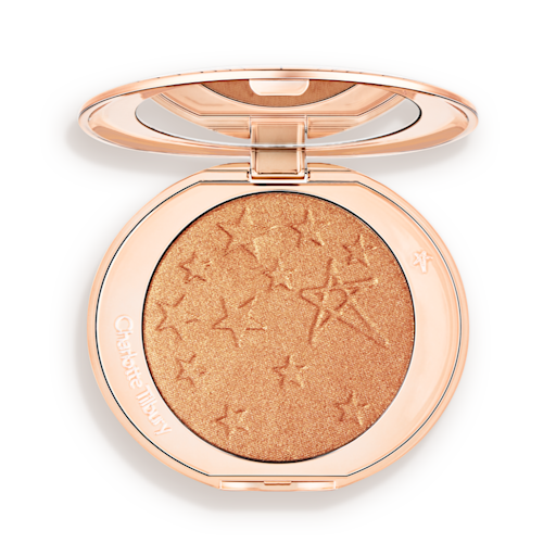 Hollywood Highlighter in Sunset Glow open An open highlighter powder compact with a mirrored lid, in a shimmery copper-gold shade.