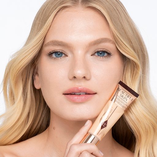 Beautiful Skin Foundation in 3N on light-tone model after application Light-tone blonde model wearing glowy, skin-like foundation with a satin finish with nude lipstick and subtle eye makeup.