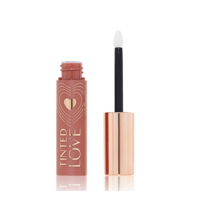 An open lip and cheek tint with a gold-coloured lid in a soft nude brown-coloured tube.