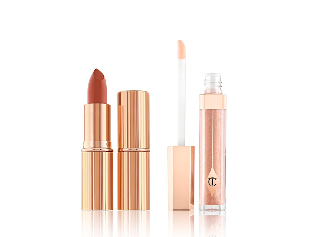 Lip Lustre in Ibiza Nights and KISSING in Stoned Rose open Two lipsticks, with and without lid in a dark peach shade with a nude peach lip gloss with its doe-foot applicator next to it.