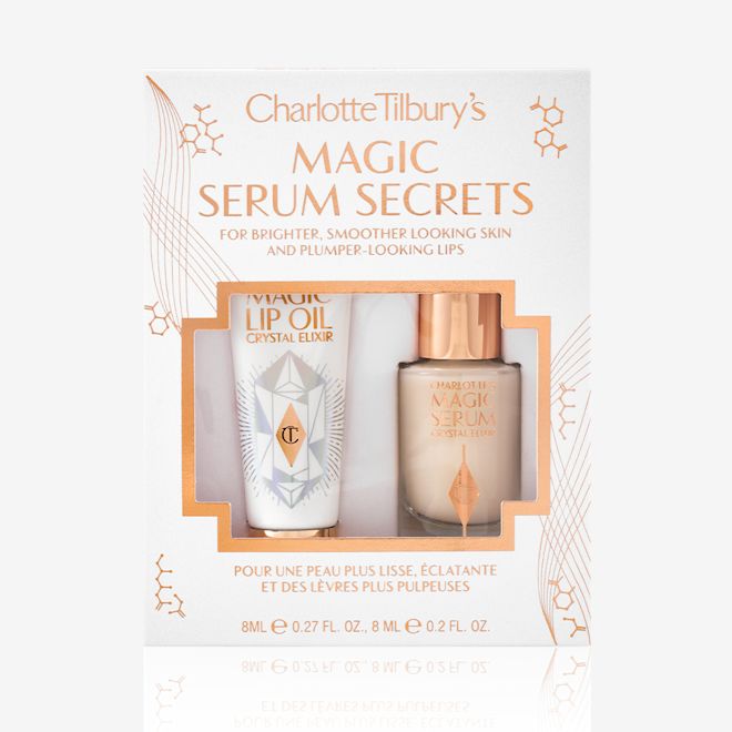 Magic Serum Secrets packed Travel-size lip oil in a white-coloured tube with a gold-coloured lid and a mini, glow-enhancing serum in a glass bottle with a gold and white-coloured dropper lid packed in their gift sleeve in white colour with the text, 'Magic serum secrets' written on it'.