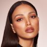 Quick & Easy Instant 5 Minute Super Chic Look on medium-tone brunette model Medium-tone brunette model with brown eyes wearing nude brown matte eye makeup with nude pink lip and cheek cream as blush and lipstick, and glowy opal-coloured highlighter.