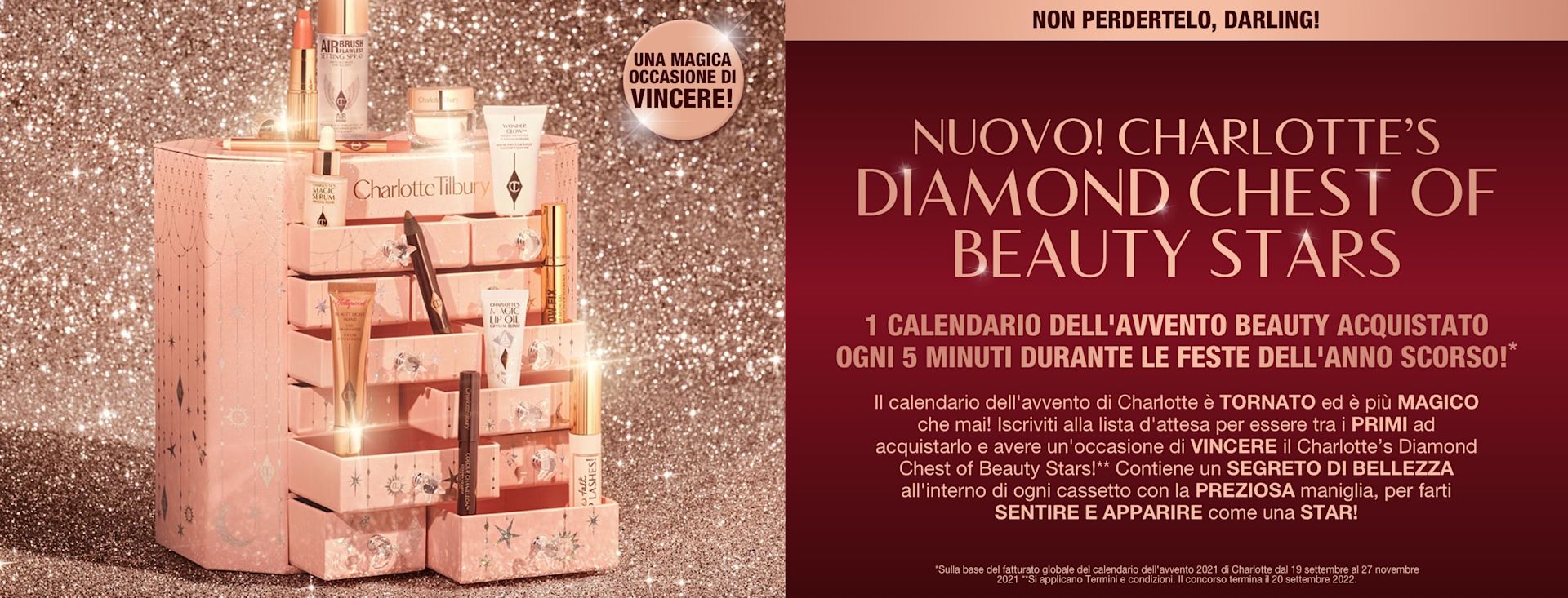 IT HOLIDAY22-ADVENT-CONTENT-HERO-MB-min A pink-coloured chest of drawers with a clay mask, nude pink matte lipstick, nude pink lip liner, eyeliner pencil in dark copper, black-coloured mascara, liquid primer, champagne-coloured liquid highlighter, dark brown eyeliner pencil, pearly-white face cream, luminous ivory-coloured serum, and bronze-coloured body highlighter., and text that reads, 'A magical chance to win!'