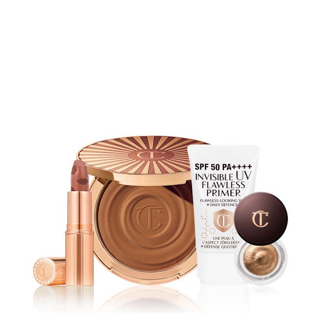 Summer Glow Look Feeling Kit An open nude terracotta lipstick in golden-coloured packaging, open cream bronzer compact in a dark brown shade, SPF-infused primer in white packaging, and cream eyeshadow in a dark gold shade with a dark brown lid.